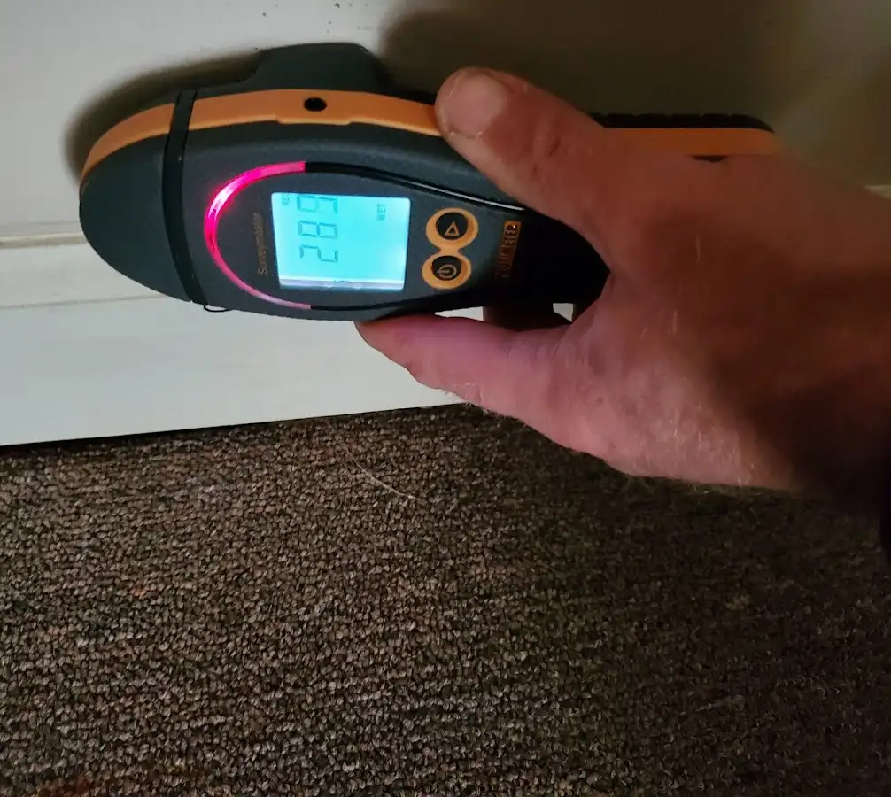Moisture detection at baseboard during Storm Damage Restoration in Bay Minette